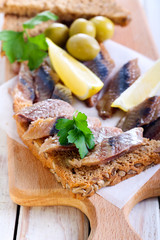 Smoked fish pieces on brown seed bread