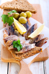 Smoked fish pieces on brown seed bread