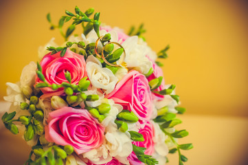 two rings lie on a bouquet