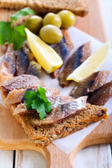 Smoked fish pieces on brown seed bread