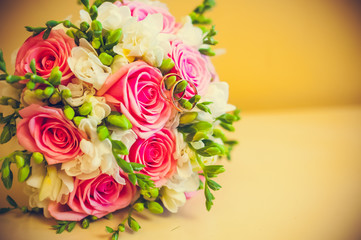 two rings lie on a bouquet