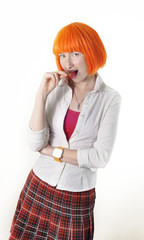 girl with red hair dressed as schoolgirl sucks a lollipop
