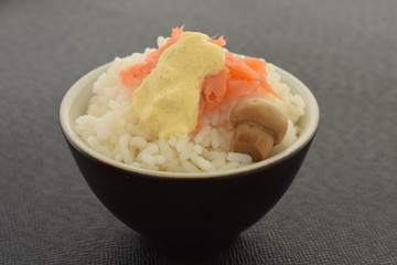 Sushi with salmon champignon and sauce in a bowl.