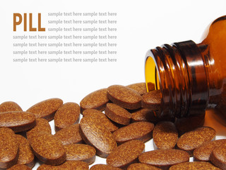 medicine pills spilling out of a pill bottle isolated on white b