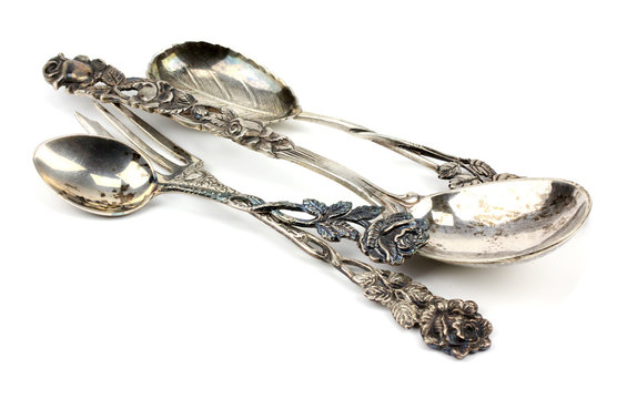 silver spoon and fork on a white background