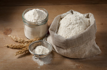 Spikelets and flour in the bag, jar on the boards
