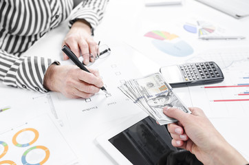 Business people exchanging dollar banknotes