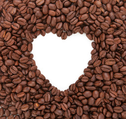 Background from coffee beans laid out in the form of heart. Conc