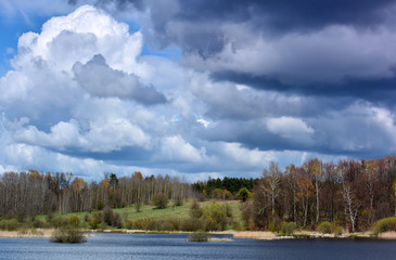 Fototapeta na wymiar Wild spring landscape with lake and clouds