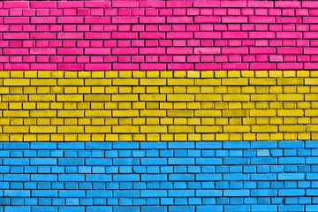 Fototapeta na wymiar flag of Pansexual Pride painted on brick wall