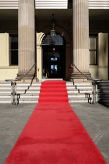 Red carpet at the entrance to a luxury hotel cinema or movie theater awards ceremony with steps stairs photo