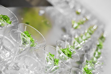 Many glasses with salad leaves