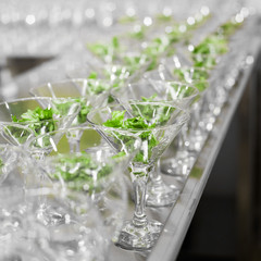 Many glasses with salad leaves