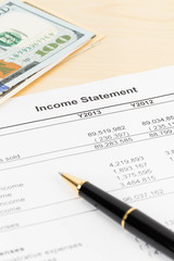 Income statement financial report with pen, and banknote
