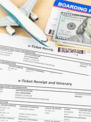 E-ticket with plane model, banknote, and boarding pass