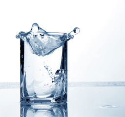 water and ice cubes in a tall glass