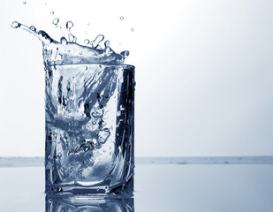 water spray and ice in a glass