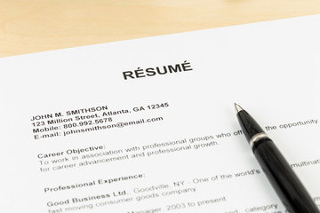 Resume with pen on table closeup