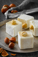 Turkish delight. Eastern dessert with hazelnut on metal plate