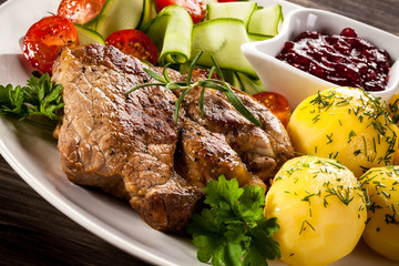 Fried steak, boiled potatoes and vegetable salad