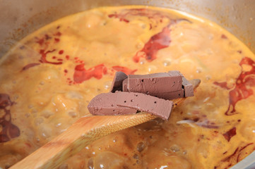 Slice chicken blood in red soup