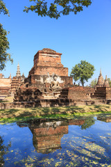Fototapeta na wymiar Buddha statue and pagoda in Wat Maha That, Shukhothai Historical
