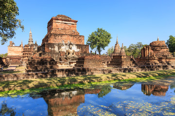 Fototapeta na wymiar Buddha statue and pagoda in Wat Maha That, Shukhothai Historical