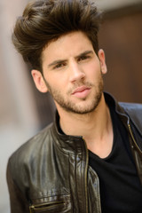 Obraz premium Attractive young handsome man, model of fashion in urban backgro