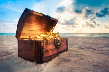 Open treasure chest on the beach