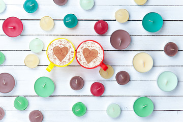 Cappuccino and candles on white background