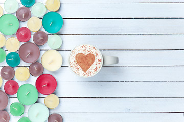 Cappuccino and candles on white background