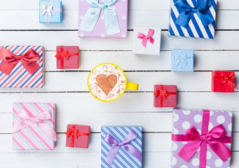 Fototapeta premium Cup of Cappuccino and gift boxes