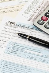 Tax form with pen, and calculator taxation concept