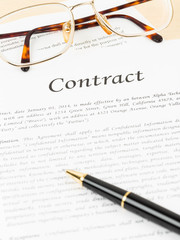 Business contract document with pen and glasses
