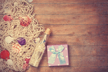 Net, gift and shells with bottle