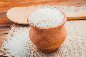 rice in a pot and spoon on burlap