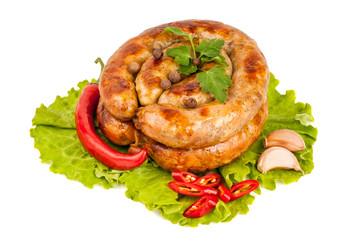 Two rings of smoked sausage with pepper, garlic and parsley lyin