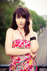 A woman in a dress standing on the street