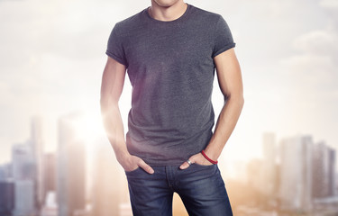 Man wearing blank t-shirt on blurred megalopolis background