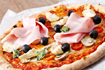 Pizza with olives, ham and mushrooms