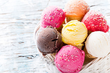 Ice cream scoops on wooden table.