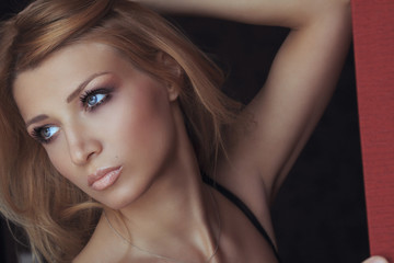 Fototapeta premium Portrait of a beautiful girl on dark background