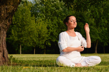 Young woman during yoga meditation in the park