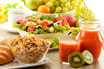 Breakfast with coffee, juice, croissant, salad, muesli and egg
