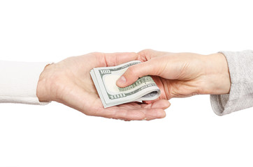 Hand giving money to other hand.