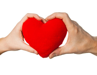 Fototapeta premium Soft red heart in woman and man hands