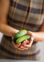 Closeup on housewife showing cucumbers