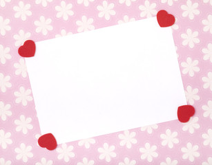 Blank celebrations card with red felt shaped hearts.