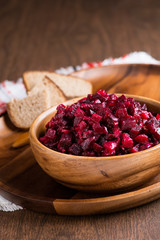 Russian beetroot salad in wooden bowl