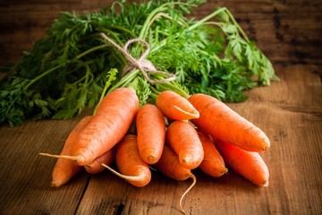 fresh organic carrots bunch on wooden background